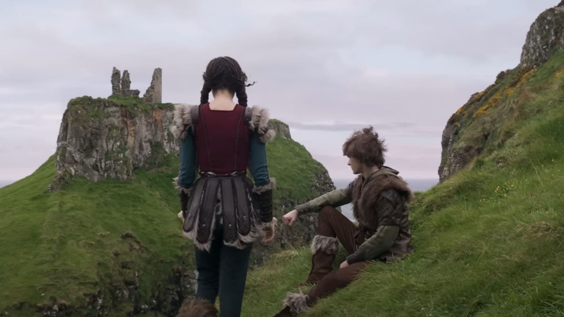 Astrid and Hiccup converse on a hill overlooking Berk (Image via YouTube/Universal Pictures)
